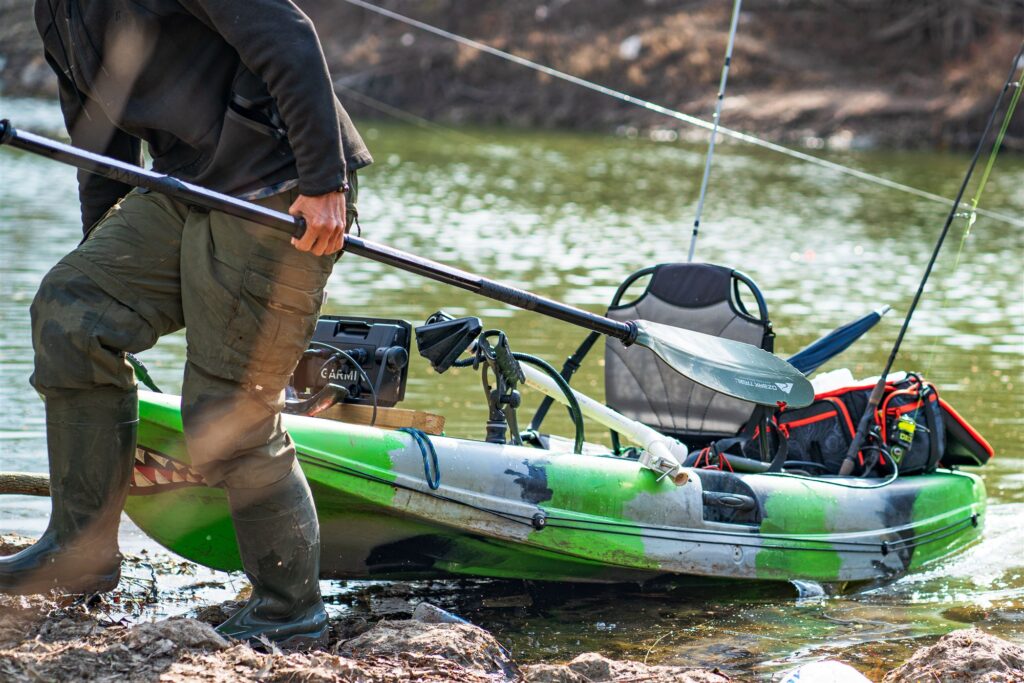 Angler launching a fishing kayak on a South Carolina blackwater river