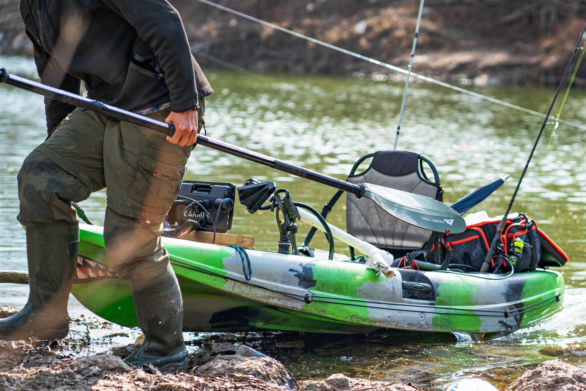 Angler launching a fishing kayak on a South Carolina blackwater river